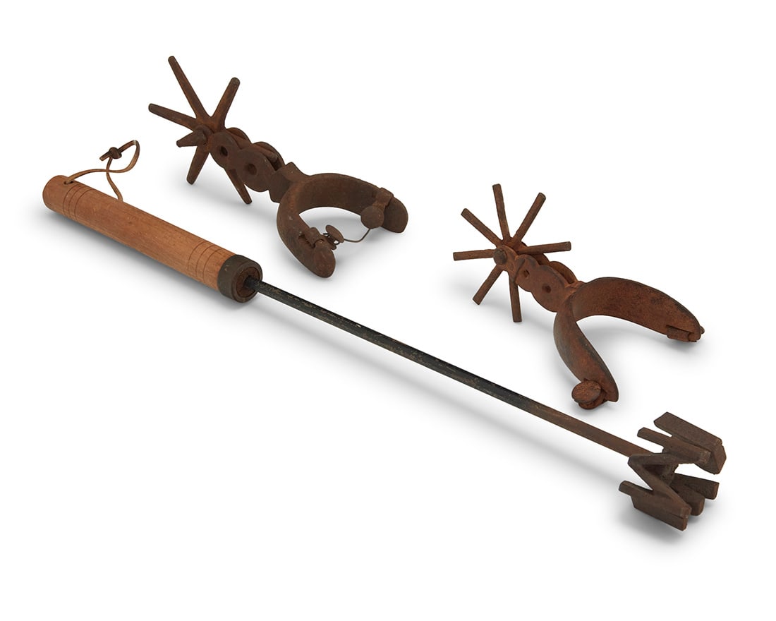 A group of vintage spurs and a branding rod (1 of 3)