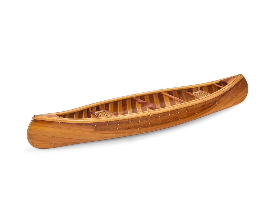 A carved wood scale model of a canoe: A carved wood scale model of a canoe Late 20th century Unmarked Lacquered wood with brass hardware 8" H x 14.5" W x 57.5" D