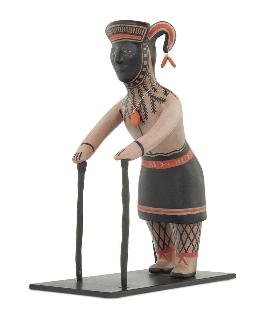 Mary Janice Ortiz (b. 1956, Cochiti Pueblo), A polychrome pottery standing figure, late 20th/early: Mary Janice Ortiz (b. 1956, Cochiti Pueblo) A polychrome pottery standing figure, late 20th/early 21st century Signed to underside: M. J. Ortiz / Cochiti, NM Depicted with canes, decorated with black