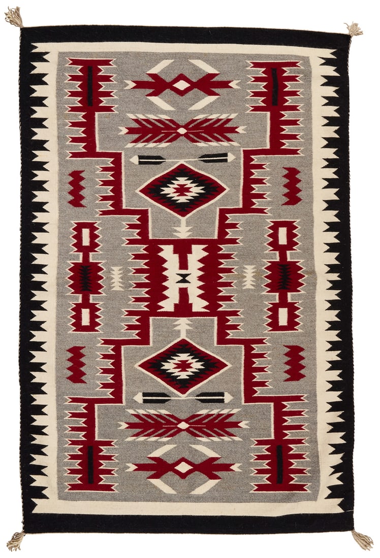 A Navajo storm pattern rug: A Navajo storm pattern rug Mid/late 20th century, Dine Woven in red, cream, grey, and black wool with a central X-form complex storm pattern motif and with waterbug, feather, and serrated diamond