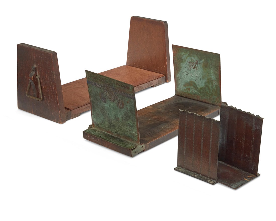 Two Arts & Crafts book stands and a pair of Roycroft bookends: Two Arts & Crafts book stands and a pair of Roycroft bookends Early 20th century Each bookend impressed with Roycroft orb Comprising a wood stand with opposed handles, a stand with wood base and