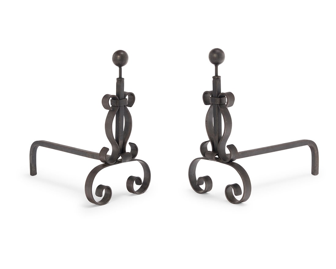 A pair of Spanish Revival style metal andirons: A pair of Spanish Revival style metal andirons 20th century Each with scrollwork and a ball finial 2 pieces Each: 19.5" H x11" W x 21" D Provenance: Private collection, Burbank, CA