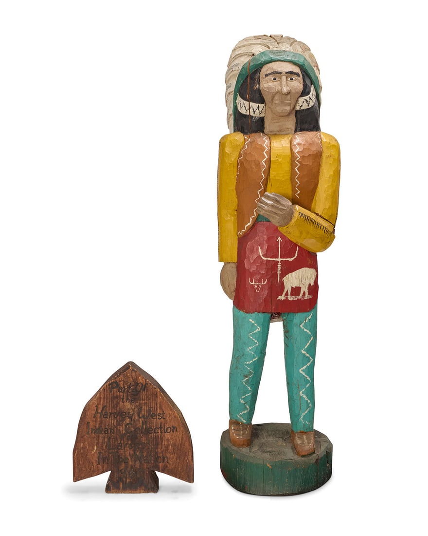 An American painted carved wood cigar store Indian statue: An American painted carved wood cigar store Indian statue Circa 1960 With carved inscription to arrowhead: Part Of / the / Harvey West / Indian Collection / Largest / In The Nation / 1960 With a