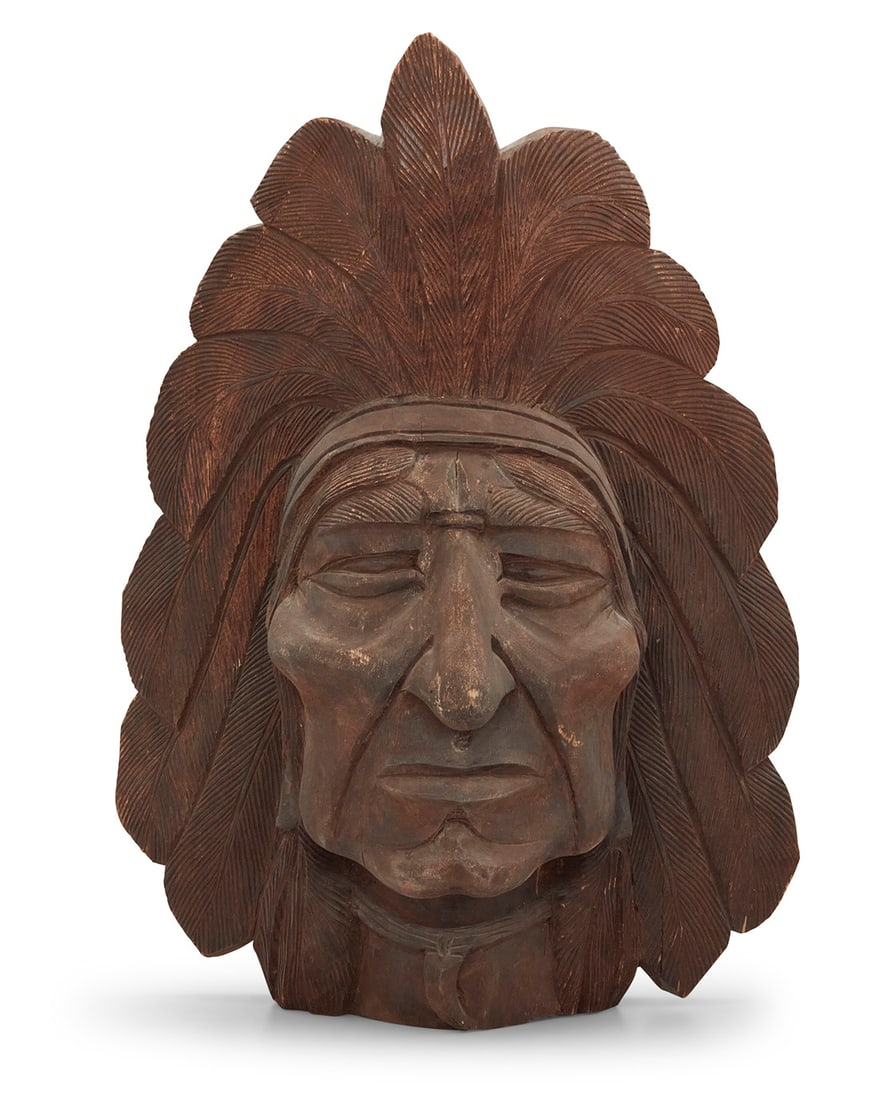 A Folk Art carved wood Indian head: A Folk Art carved wood Indian head Mid-20th century Unmarked 22.625" H x 17.25" H x 8.25" D Provenance: The Collection of Gary Diamond, Los Angeles, CA