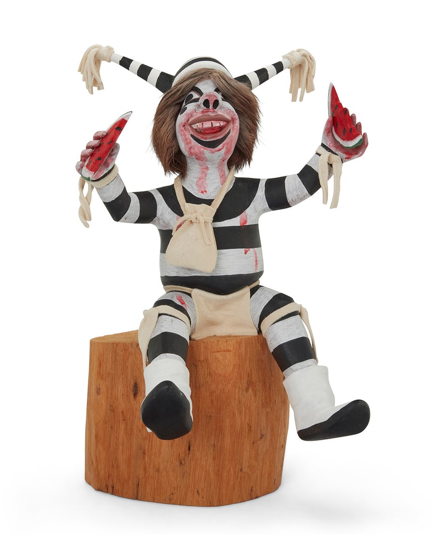 Manuel Cleveland (b. 1964, Hopi-Tewa), A painted carved cottonwood Koshare clown katsina, 1986: Clarence Cleveland (20th century, Hopi-Tewa) A painted carved cottonwood Koshare clown katsina, 1986 Signed to underside: CLEVELAND; dated, possibly in another hand: 12-31-86 Mounted with hide and