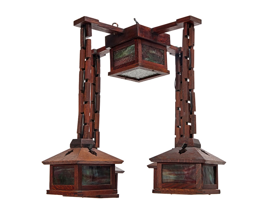 An Arts & Crafts wood and slag glass chandelier: An Arts & Crafts wood and slag glass chandelier Early 20th century Each lower fixture with 'Union' knob switch Possibly W. B. Brown (1906-1923), with five lights, each housed in a slag glass and wood