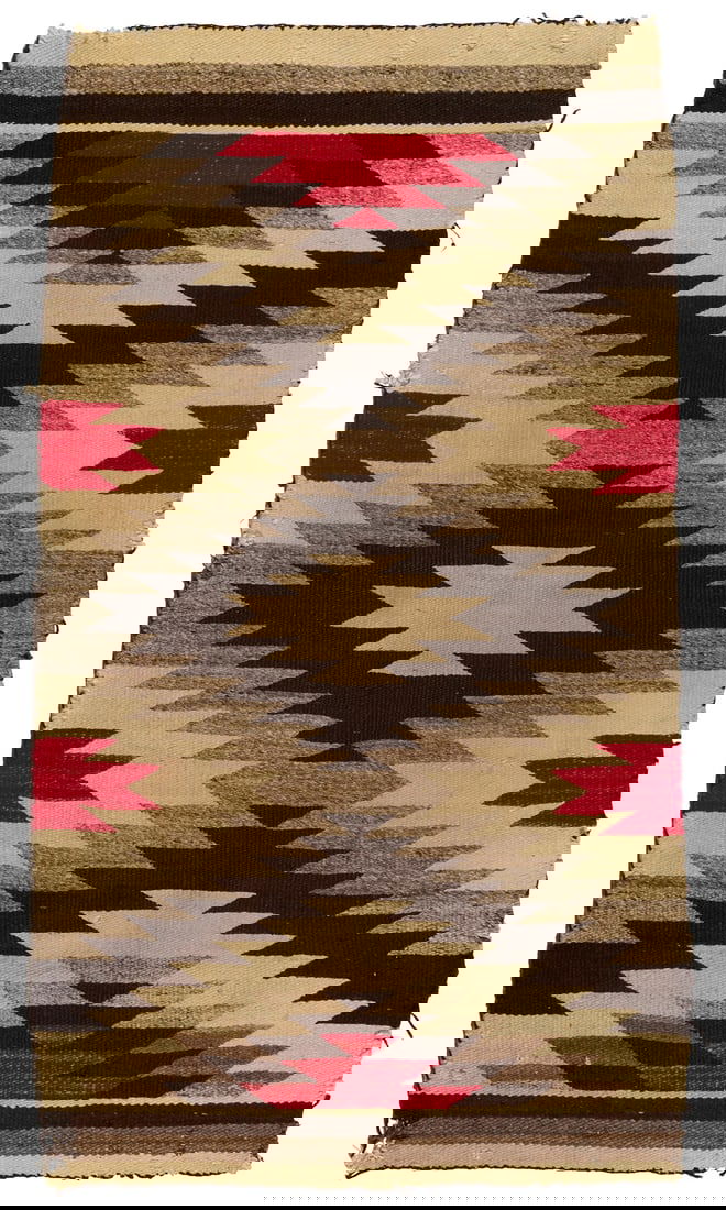 A Navajo regional rug: A Navajo regional rugEarly 20th century, DineWoven in red, cream, dark brown, and natural grey wool, with stacked serrated diamonds55" H x 31.5" W