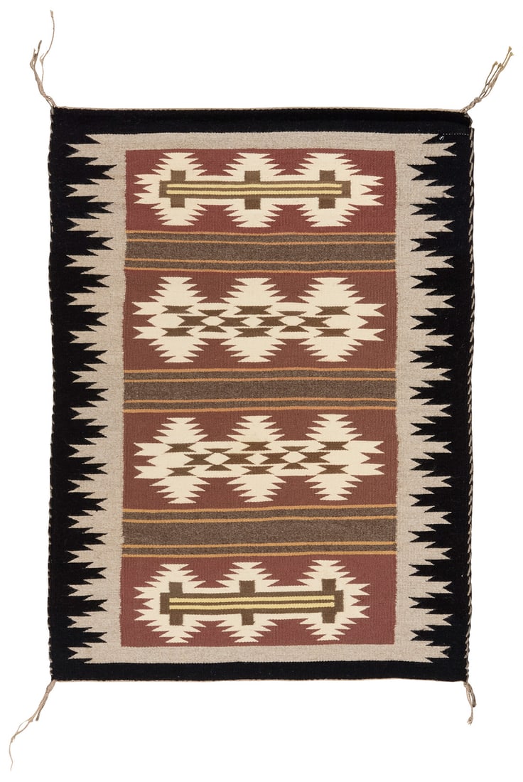 A Navajo Wide Ruins textile: A Navajo Wide Ruins textileLate 20th century, DineWoven in grey, black, brown, yellow, and cream wool featuring four rows of conjoined serrated diamonds alternating with striped banding, with a comple