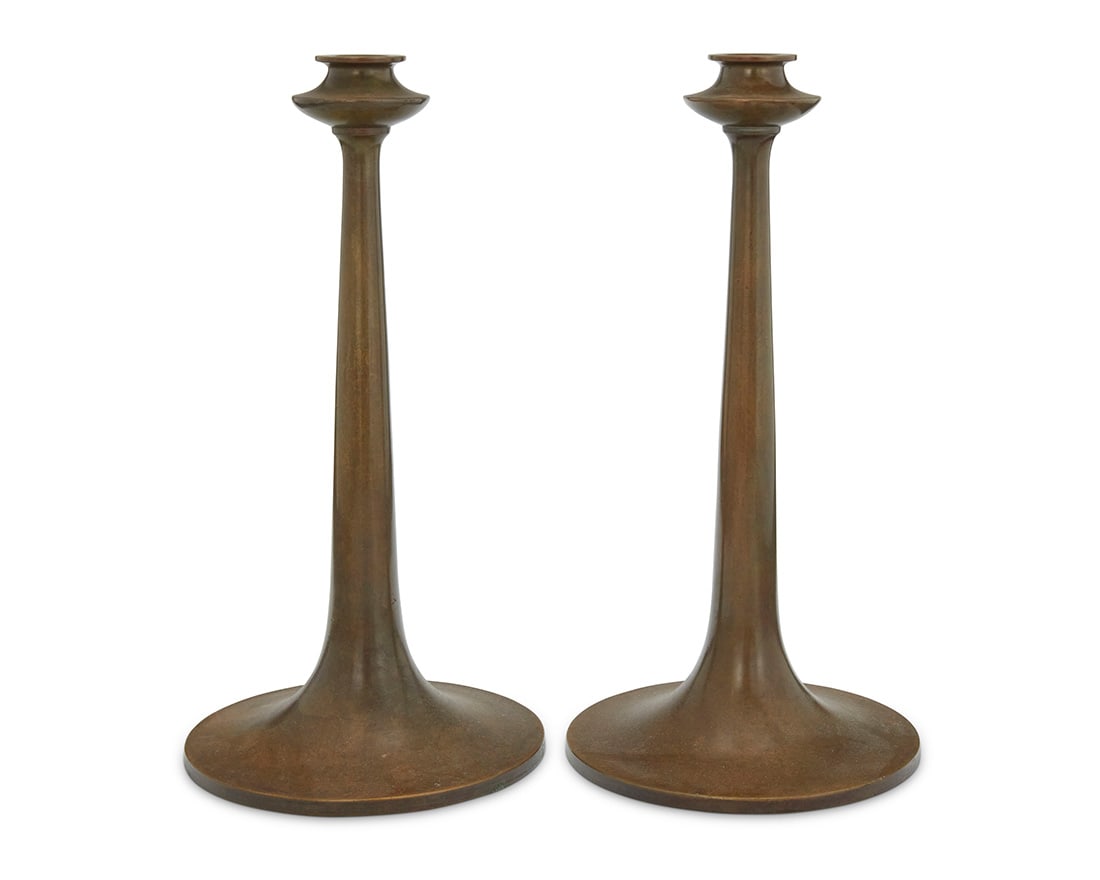 A pair of Bradley & Hubbard brass candlesticks: A pair of Bradley & Hubbard brass candlesticks Early 20th century Each applied with metal tag: BRADLEY & HUBBARD / [lamp cipher] / MFG. CO. 2 pieces Each: 12" H x 6.25" Dia. Provenance: The