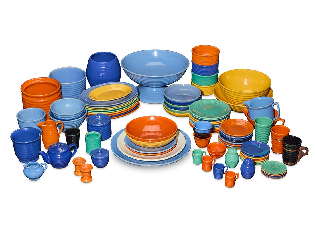 A collection of Bauer glazed pottery ringware table items: A collection of Bauer glazed pottery ringware table itemsCirca 1930sEach unmarkedComprising various plates, bowls, cups, and other service items, including but not limited to: a large footed fruit bow