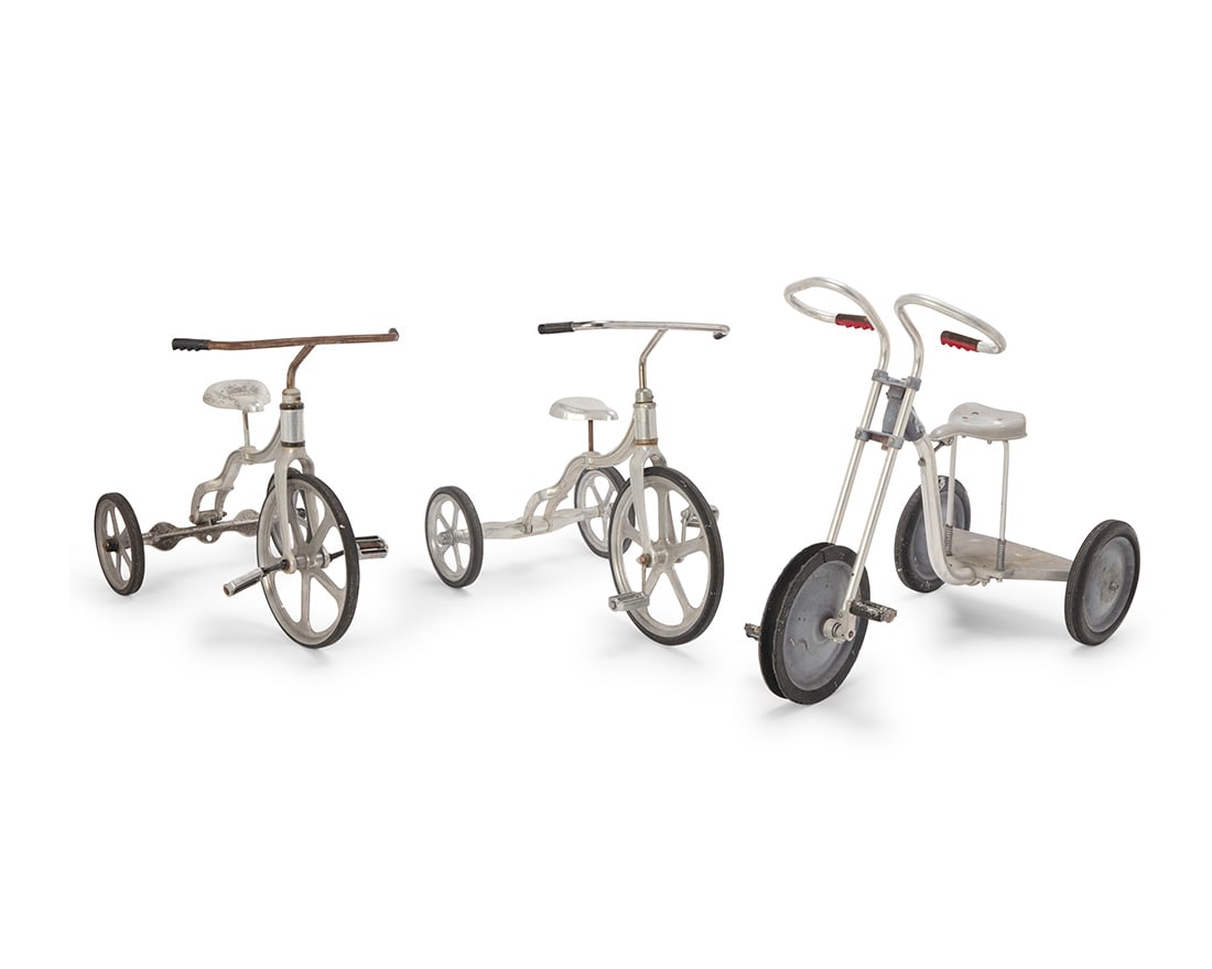 Three American aluminum tricycles: Three American aluminum tricycles Mid-20th century Two with pedals marked in the casting: ANTHONY BROTHERS; largest marked to handlebar stem: T-F A200 Each with rubber wheels, comprising two Anthony
