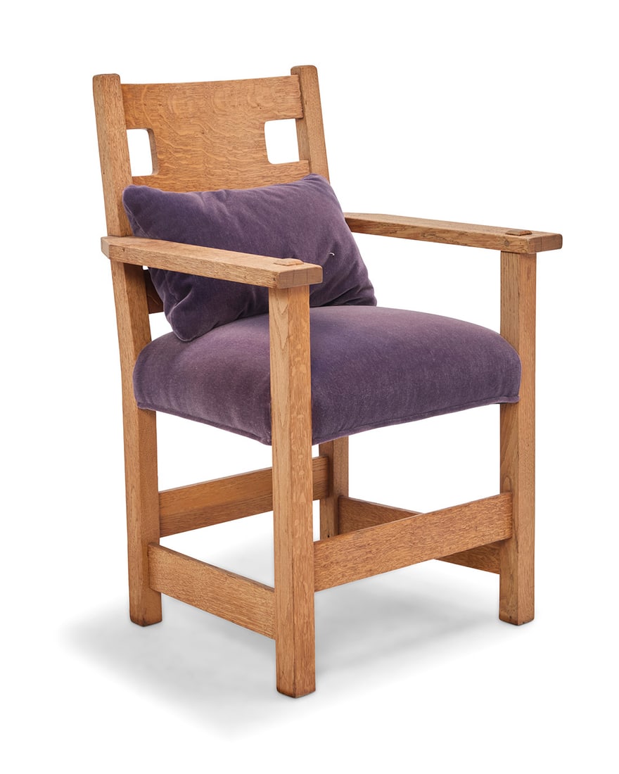 A Limbert oak cutout armchair: A Limbert oak cutout armchairEarly 20th centuryWith shop burn mark underneath one armSimilar construction to model no. 594, but without rockers, the seat later reupholstered in purple mohair35.75" H x