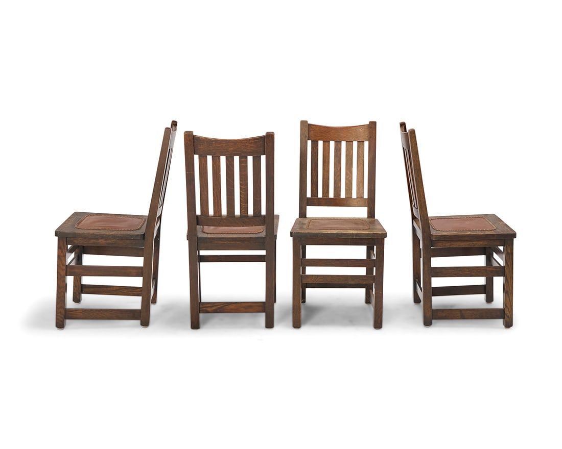 Four Limbert Mission oak side chairs, no. 1851: Four Limbert Mission oak side chairs, no. 1851 Circa 1910 Each appears unmarked Each with slat back above a later leather seat with tacking 4 pieces Each: 36.75" H x 17.5" W x 20" D Literature:
