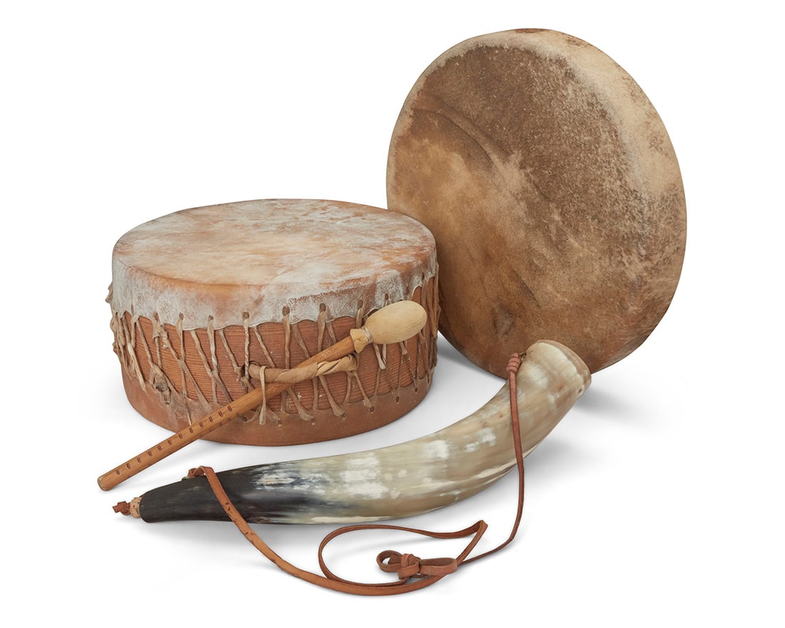 A group of hide drums and a powder horn: A group of hide drums and a powder horn Late 20th/21st century Hand drum signed: Nash Tavewa / 23 / 2023 Comprising a Nash Tavewa (Zapotec) smaller single-sided stretched hand drum and a large
