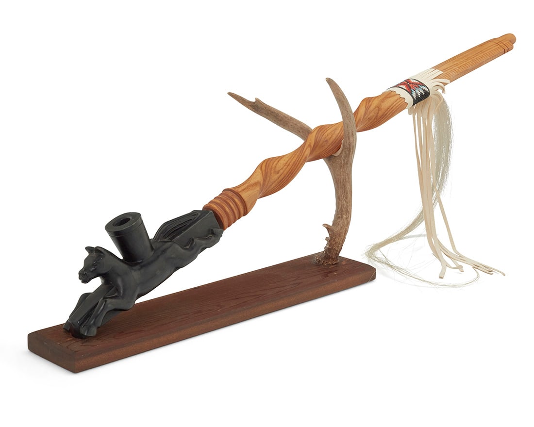 Adam Fortunate Eagle (b. 1929, Chippewa), 'Medicine Horse Society Pipe," 1992: Adam Fortunate Eagle (b. 1929, Chippewa)'Medicine Horse Society Pipe," 1992Signed and dated to the pipe end and the stand base: Fortunate Eagle / 1992A carved steatite horse pipe bowl with a removable