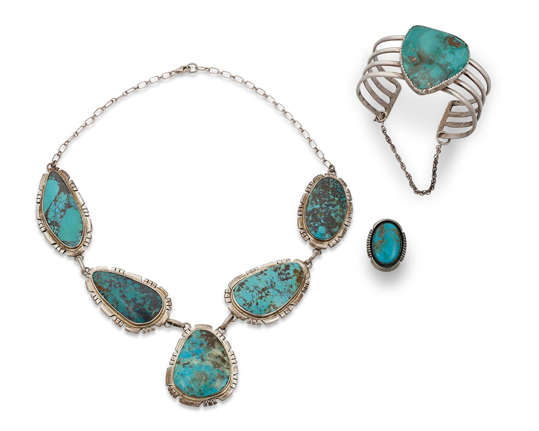 A group of Southwest sterling silver and turquoise jewelry: A group of Southwest sterling silver and turquoise jewelry Mid/late 20th century Cuff etched: Ralph King / 1975; two marked: Sterling Comprising a sterling silver chain link pendant necklace with