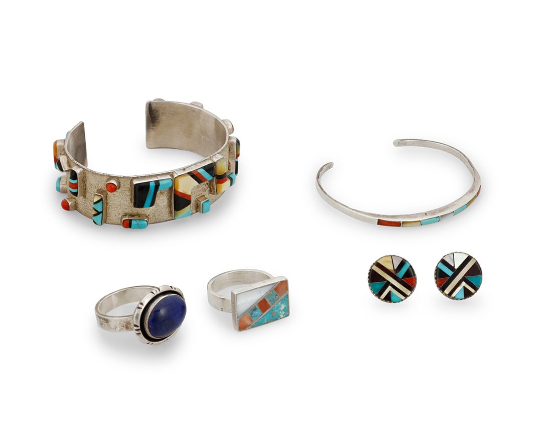 A group of Southwest silver and stone set jewelry: A group of Southwest silver and stone set jewelryLate 20th centuryCuff marked: AC [or G] / Sunburst / Sterling; earrings with label for Tracey Bowekaty, ZuniFive works comprising a textured sterling s