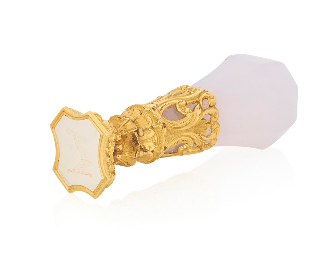 An 18K Gold and Blue Chalcedony Wax Seal: An 18K Gold and Blue Chalcedony Wax Seal Featuring a carved blue chalcedony handle featuring an ornately etched gold embellishment finished with a chalcedony carved intaglio seal, in original fitted