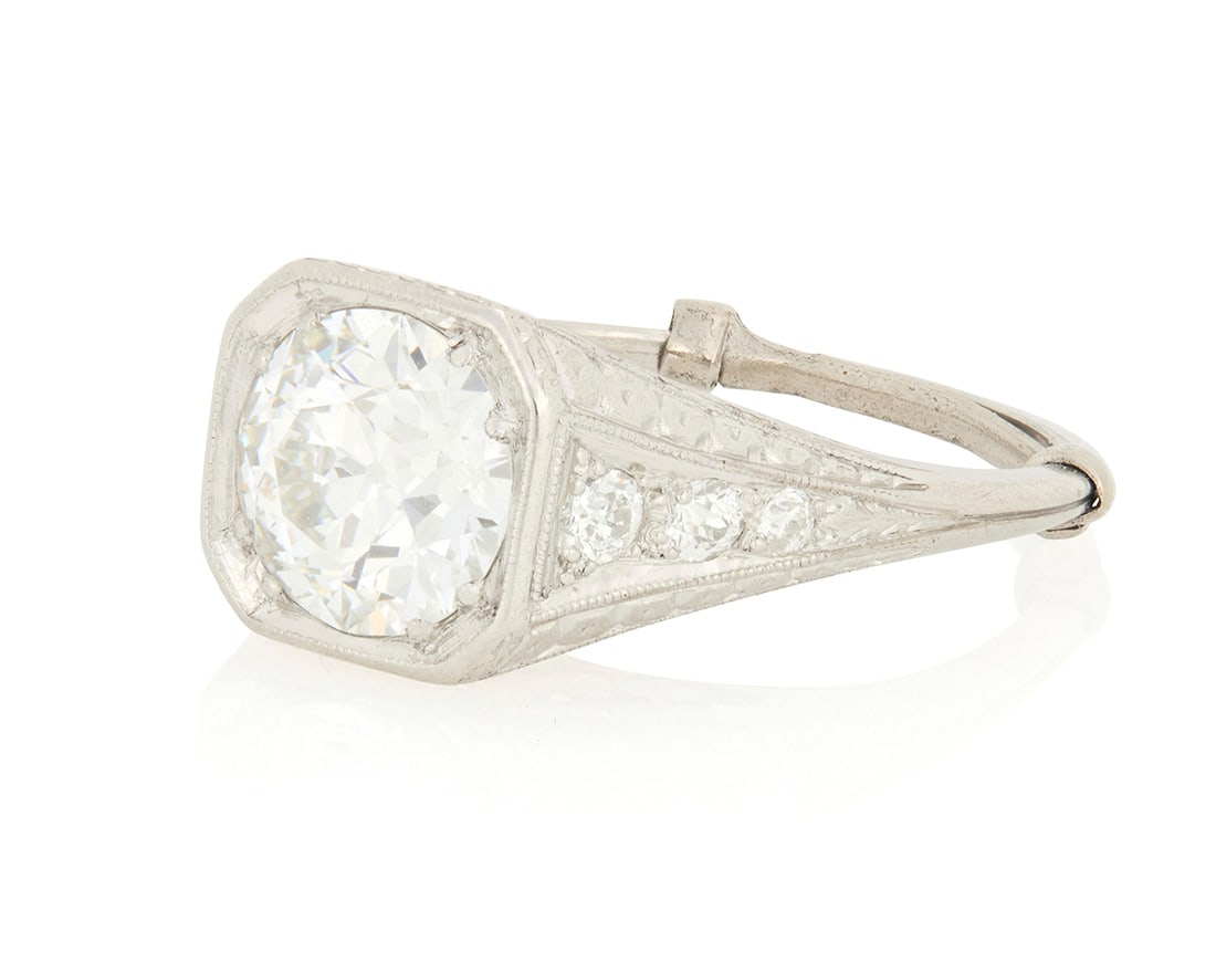 A Platinum and Diamond Ring: A Platinum and Diamond RingCentering a round brilliant-cut diamond weighing 2.04 carats, accented by six round diamonds set in a floral filigree mountingSize: 7 1/2 with sizing band44.8 grams grossAcc