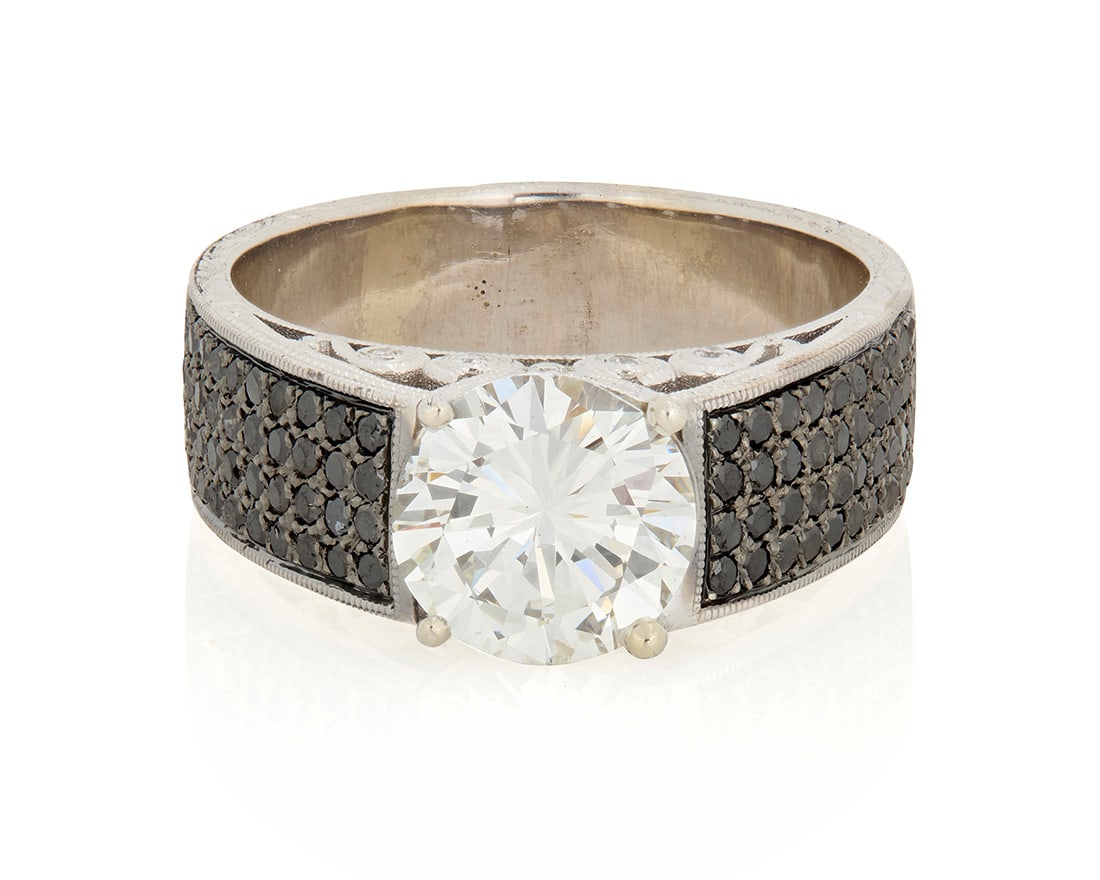 A 14K White Gold, Diamond and Black Diamond Ring: A 14K White Gold, Diamond and Black Diamond Ring Centering a round brilliant-cut diamond weighing 2.73 carats, accented by round black and near-colorless diamonds set in a scrolling motif white gold