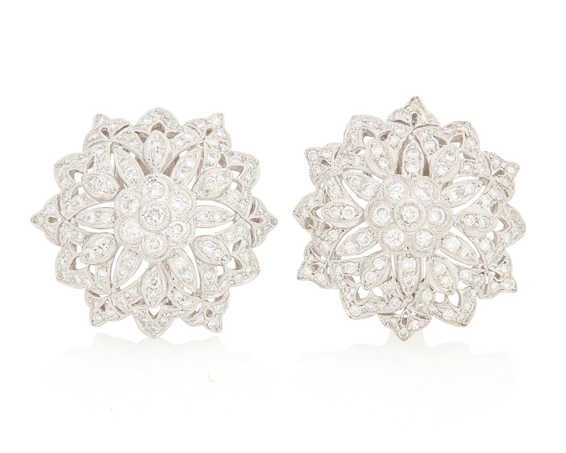A Pair of 18K White Gold and Diamond Earclips: A Pair of 18K White Gold and Diamond Earclips Of an openwork floral design set with round diamonds weighing 5.10 carats 2 pieces Measures: 1 1/8 x 1 1/8 in. 19.2 grams gross