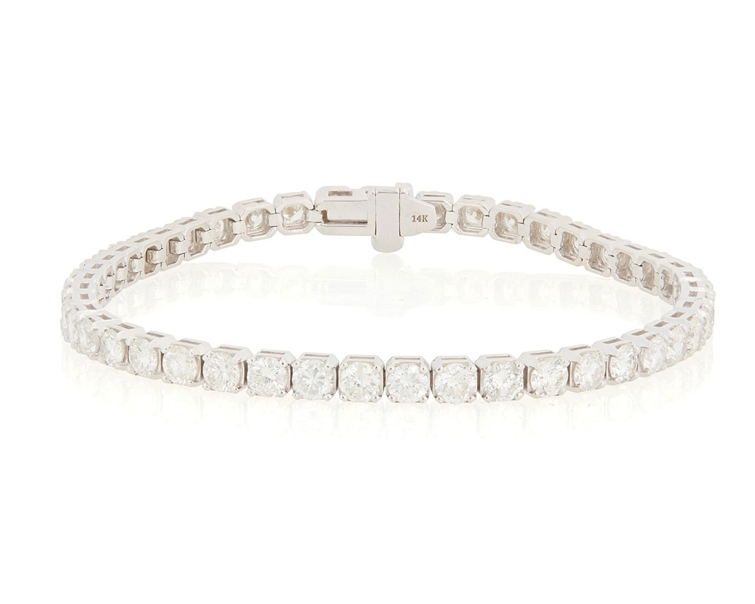 A 14K White Gold and Diamond Bracelet: A 14K White Gold and Diamond Bracelet Of a single line design set with forty-five round diamonds weighing approximately 7.40 carats Length: 7 1/4 in. 11.9 grams gross