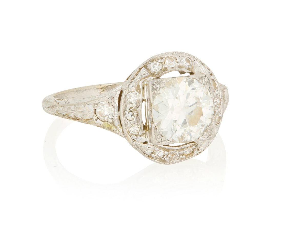 An 18K White Gold and Diamond Ring: An 18K White Gold and Diamond Ring Centering an old European-cut diamond weighing approximately 1.00 carat, accented by single-cut diamonds Size: 6 1/2 3.4 grams gross