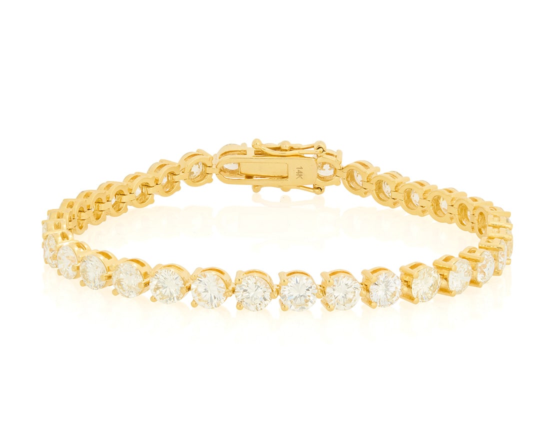 A 14K Gold and Diamond Bracelet: A 14K Gold and Diamond Bracelet Of a single line design featuring thirty-three round diamonds weighing approximately 11.79 carats Length: 7 1/2 in. 14.5 grams gross