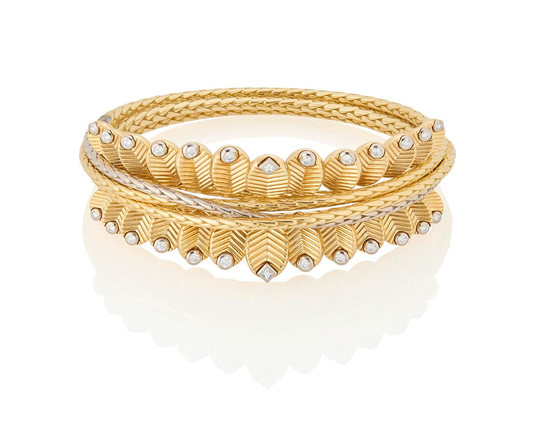 Cartier: An 18K Bi-Color Gold and Diamond 'Grain de Cafe' Bracelet: Cartier: An 18K Bi-Color Gold and Diamond 'Grain de Cafe' Bracelet Featuring braided twisted bands of white and yellow gold, accented by articulated textured leaves tipped with round and princess-cut
