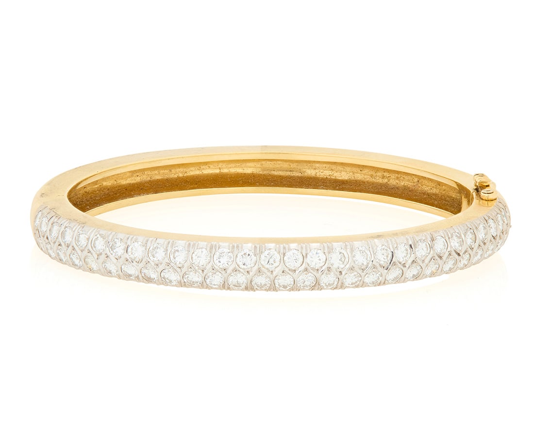 A 14K Gold and Diamond Bangle: A 14K Gold and Diamond Bangle Of a hinged design with top accents of round diamonds weighing approximately 4.06 carats Inner circumference: 6 1/4 in. 34.7 grams gross