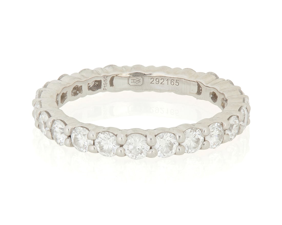 Harry Winston: A Platinum and Diamond Eternity Band: Harry Winston: A Platinum and Diamond Eternity Band Featuring twenty-four round diamonds weighing approximately 1.20 carats, signed HW, no. 292165 Size: 4 1/2 2.8 grams gross