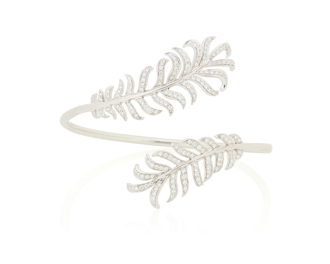 Chanel: An 18K White Gold and Diamond 'Plume de Chanel' Bracelet: Chanel: An 18K White Gold and Diamond 'Plume de Chanel' BraceletFeaturing two feathers in a bypass design set with round diamonds weighing approximately 1.77 carats, signed Chanel, T36057, with Italia