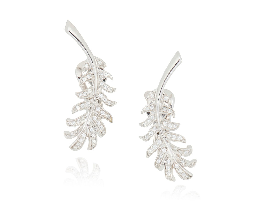 Chanel: A Pair of 18K White Gold and Diamond 'Plume de Chanel' Earclips: Chanel: A Pair of 18K White Gold and Diamond 'Plume de Chanel' Earclips Of a feather design featuring round diamonds weighing approximately 0.36 carat total, signed Chanel, T36309 2 pieces Measures: