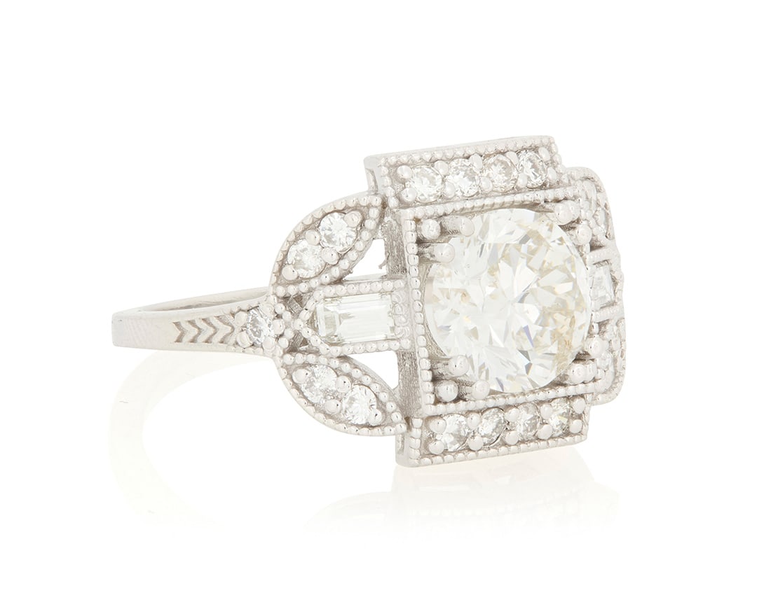 A 14K White Gold and Diamond Ring: A 14K White Gold and Diamond Ring Of an ornate geometric deign, centering a round diamond weighing approximately 1.58 carats, accented by round diamonds, Size: 7 4.7 grams gross