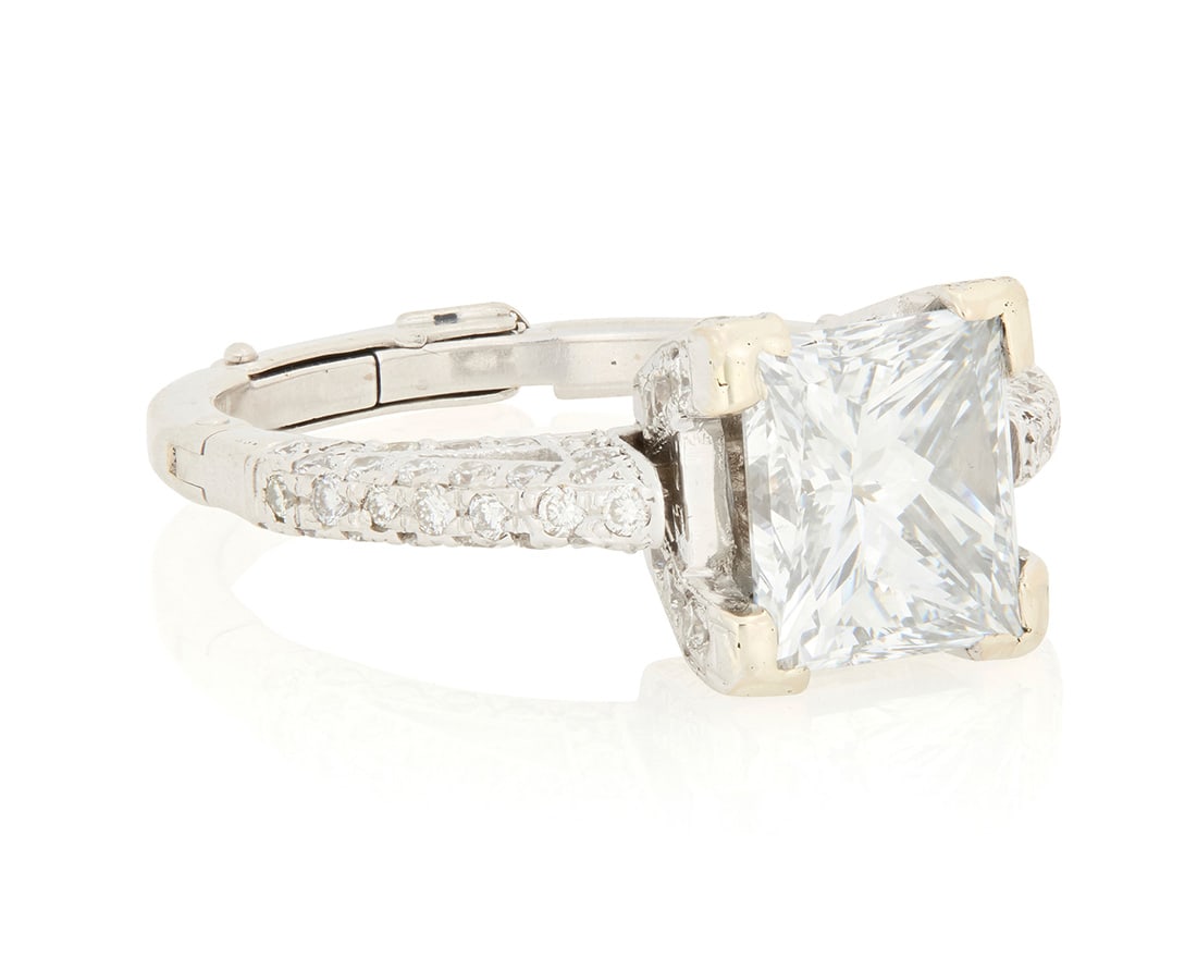 A 14K White Gold and Diamond Ring: A 14K White Gold and Diamond Ring Centering a princess-cut diamond weighing 3.05 carats, accented by round diamonds and finished with a hinged shank Size: 7 1/2 6.9 grams gross Accompanied by a GIA