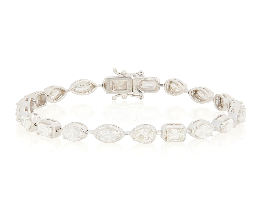 A 14K White Gold and Diamond Bracelet: A 14K White Gold and Diamond Bracelet Of a station design featuring nineteen variously cut diamonds weighing approximately 6.51 carats Length: 7 1/4 in. 13.1 grams gross