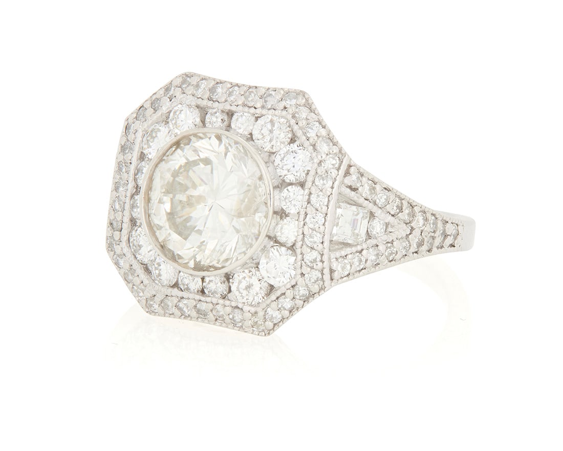 A Platinum and Diamond Ring: A Platinum and Diamond Ring Of an octagon design set with round diamonds weighing approximately 1.15 carats, centering a round diamond weighing approximately 2.01 carats Size: 7 9.6 grams gross