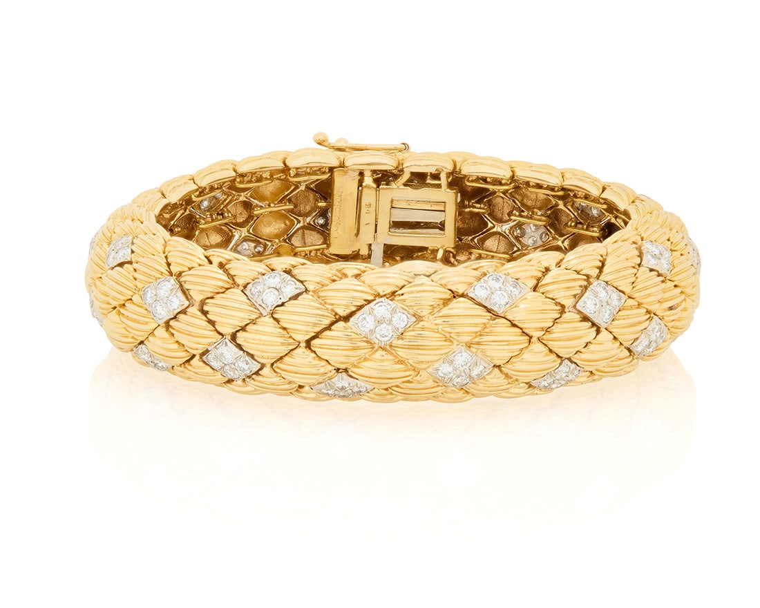 A 14K Gold, Platinum and Diamond Bracelet: A 14K Gold, Platinum and Diamond Bracelet Featuring lozenge shaped textured gold links with alternating links set with round diamonds weighing approximately 3.85 carats Inner circumference: 6 1/2