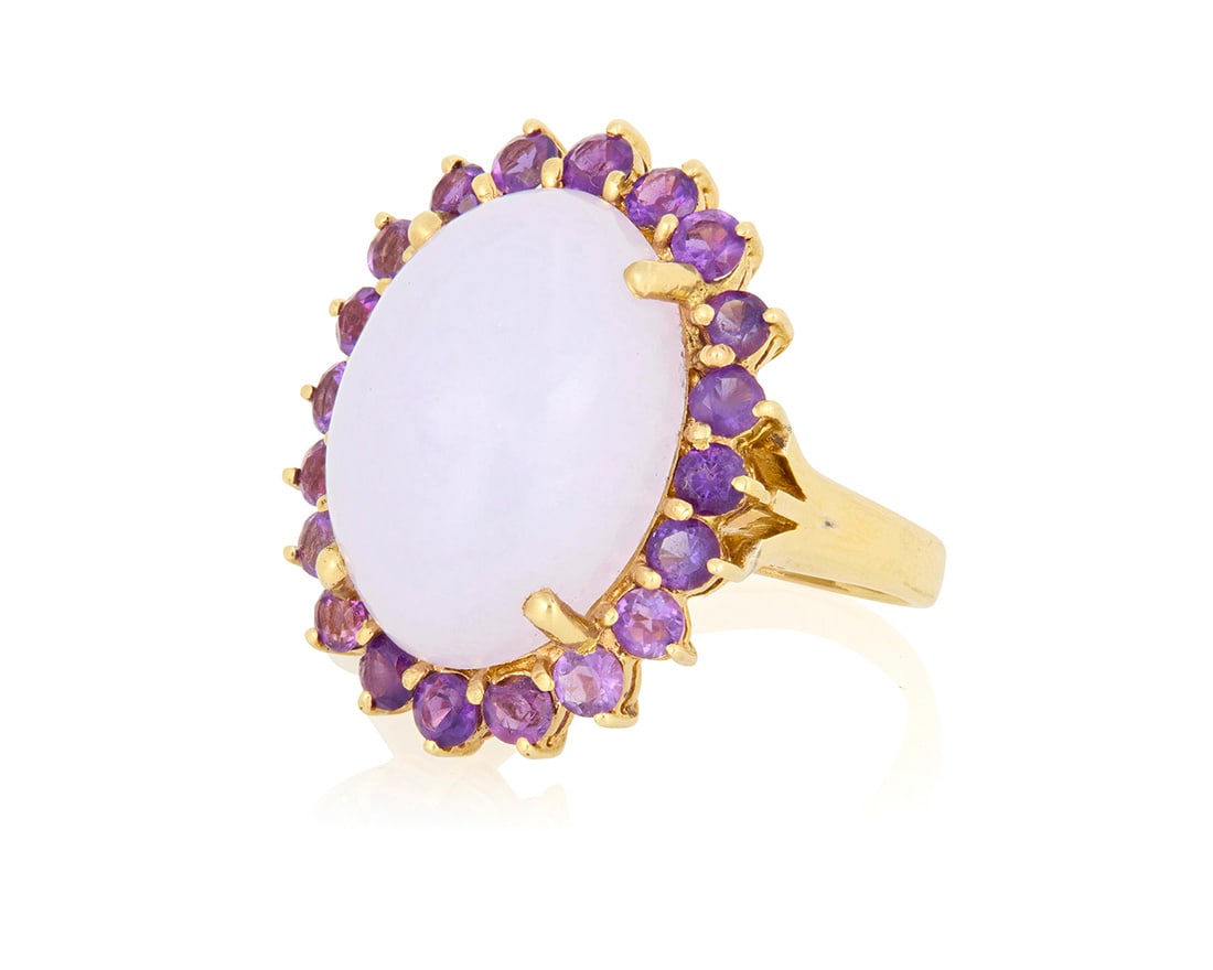 A 14K Gold, Lavender Jade and Amethyst Ring: A 14K Gold, Lavender Jade and Amethyst Ring Centering an oval lavender jade cabochon weighing approximately 21.32 carats, encircled by round amethyst Size: 9 1/4 14.0 grams gross Accompanied by a