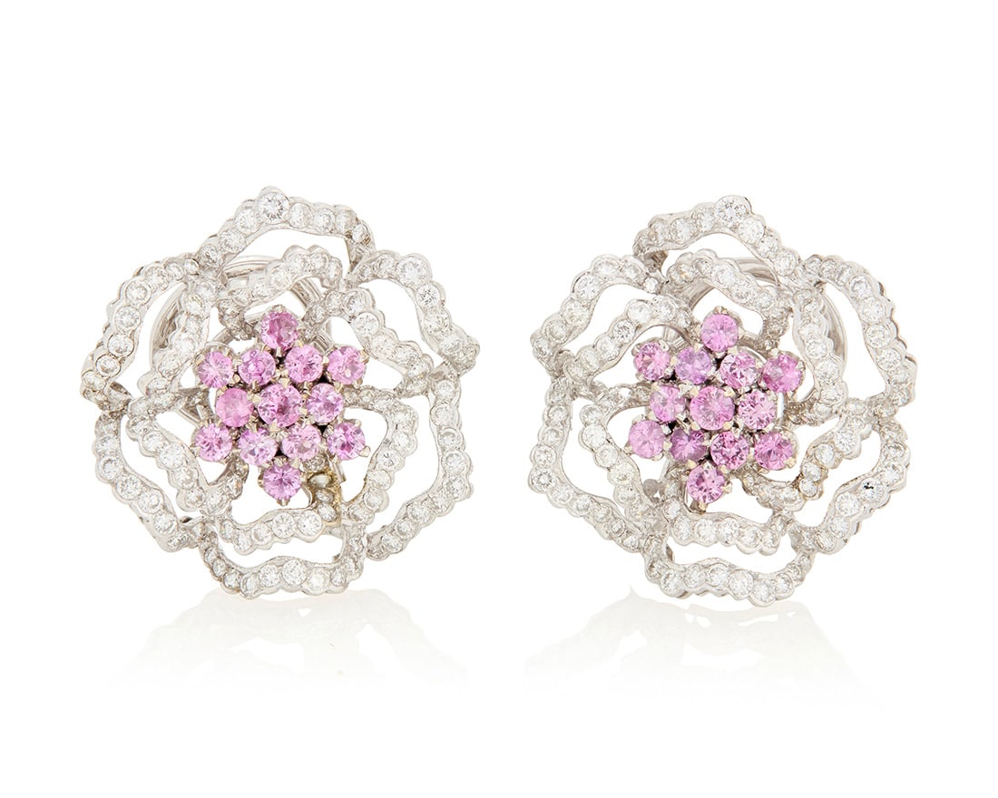 A Pair of 18K White Gold, Pink Sapphire and Diamond Earclips: A Pair of 18K White Gold, Pink Sapphire and Diamond Earclips Of an openwork floral design centering round pink sapphires accented by round diamonds weighing approximately 3.68 carats 2 pieces 