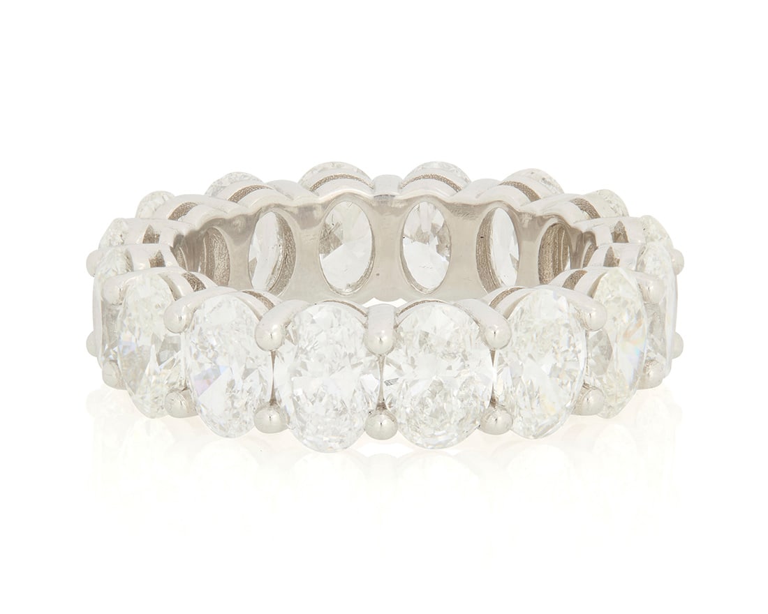 A Platinum and Diamond Eternity Band: A Platinum and Diamond Eternity Band Featuring sixteen oval diamonds weighing 8.06 carats Size: 6 1/4 8.86 grams gross