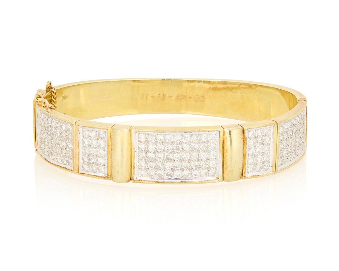 A 14K Bi-Color Gold and Diamond Bracelet: A 14K Bi-Color Gold and Diamond Bracelet Of a hinged design featuring rectangular panels set with round diamonds weighing approximately 3.10 carats Inner circumference: 7 1/4 in. 51.3 grams gross