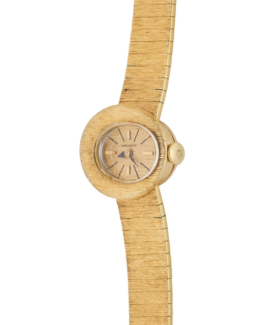 Baume Mercier: A 14K Gold Watch: Baume Mercier: A 14K Gold Watch Dial: 14.00 mm, oval with baton hour markers Case: 20.00 mm Case number:† 090686 Closure: gold bracelet with jewelry clasp Signed: dial and movement Inner