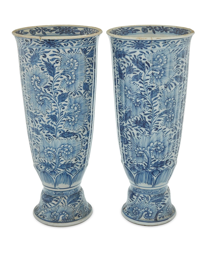 A pair of Chinese blue and white porcelain ribbed trumpet vases: A pair of Chinese blue and white porcelain ribbed trumpet vases Kangxi Period (1662-1722) Each profusely decorated with floral motifs 2 pieces Each: 10.5" H x 4.625" Dia. Provenance: Private collector
