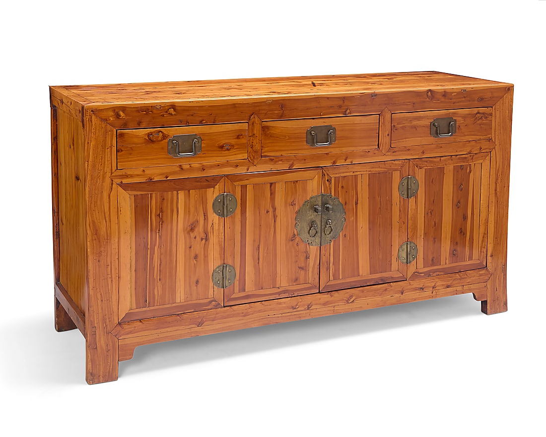 A Chinese elmwood buffet: A Chinese elmwood buffet Early 20th century With brass hardware and two drawers above cabinet doors opening to reveal a continuous compartment with single shelf 39" H x 68" W x 22" D