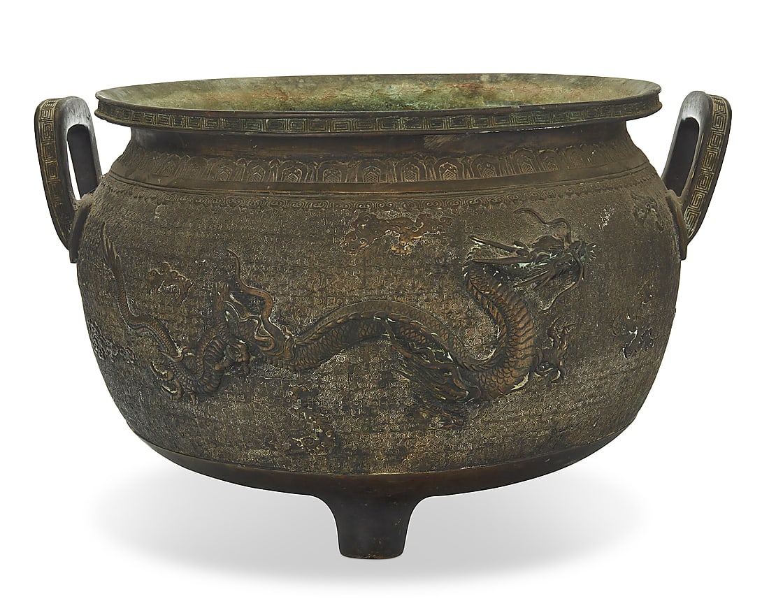 A large Japanese bronze jardinere: A large Japanese bronze jardinere Meiji Era (1868-1912) or later With impressed seal to underside With opposed handles, the body decorated with dragons and clouds in relief on a meandering ground, rai