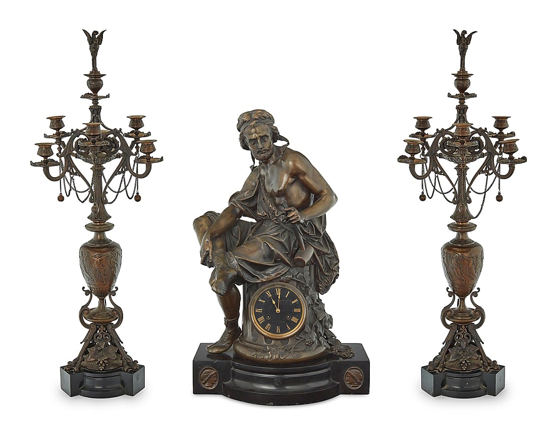 A French patinated bronze clock garniture: A French patinated bronze clock garniture The figure after Auguste-Joseph Carrier (1800-1875), late 19th/early 20th century Movement impressed: MEDAILLE DE BRONZES / S. Marti et Cie / CHARPENTIER FT D