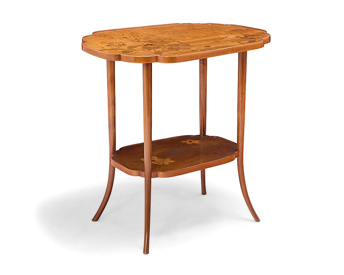 An …mile Galle marquetry two tiered table: An …mile Galle marquetry two tiered table Circa 1900 Signed in the marquetry: Galle The shaped oval top with mixed wood marquetry depicting floral and foliate motifs, raised on flared reeded legs jo