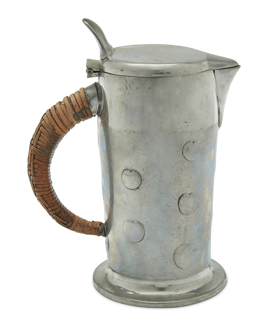 An Archibald Knox for Liberty & Co. Tudric pewter lidded jug: An Archibald Knox for Liberty & Co. Tudric pewter lidded jug Early 20th century Impressed: 3 / MADE IN ENGLAND / "TUDRIC" / 0279 / RD421109 With hinged lid and rattan-wrapped wood handle 7.5" H x 5.37