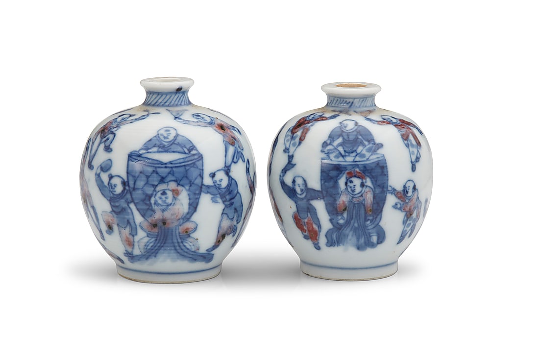 A near pair of Chinese 'One Hundred Boys' porcelain snuff bottles: A near pair of Chinese 'One Hundred Boys' porcelain snuff bottles 19th/20th century Each bearing an apocryphal blue underglaze reign mark for Yongzheng Period (1722-1735) Each with blue underglaze on 